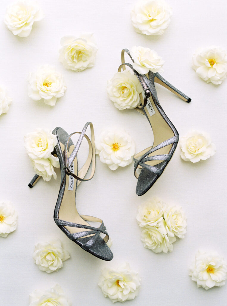 The shoes of the bride with flowers during this Wedding at Château de Varennes.